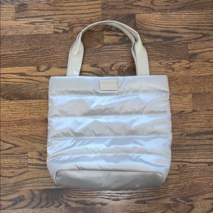 A grey Kate Spade Puffer purse